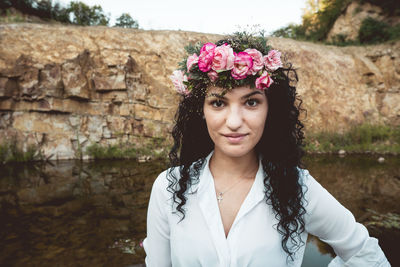 Portrait of beautiful woman with flower wreath close up