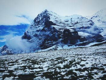 Scenic view of snowcapped mountains against sky