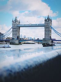 View of bridge over river against cloudy sky