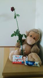 Boy with flowers in container at home