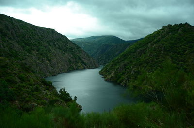 Scenic view of canyon amidst mountains against sky