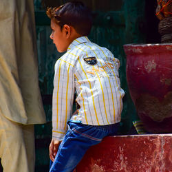 Side view of boy looking at market