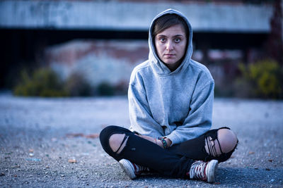 Portrait of young man sitting outdoors