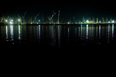 Scenic view of lake against sky at night