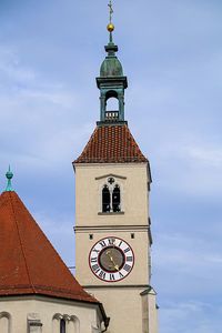 Low angle view of clock tower amidst buildings against sky