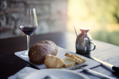 Bread and glass of wine on table