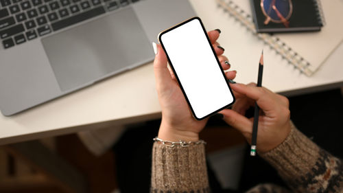 Midsection of woman using digital tablet