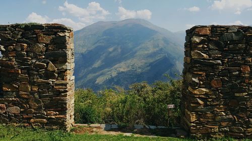 Scenic view of ruins and mountains against sky