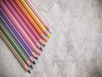 Directly above shot of colored pencils on wooden table