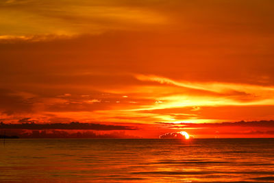 Scenic view of sea against romantic sky at sunset