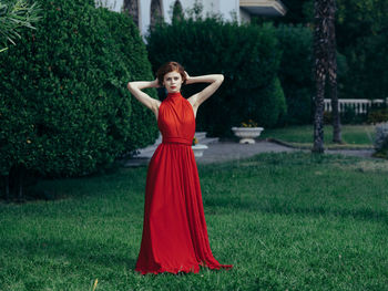 Portrait of a woman standing against plants