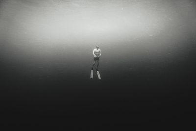 Rear view of person standing in sea