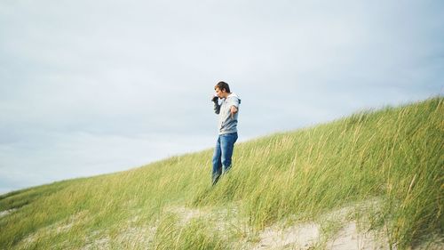 Full length of woman standing on grassy field