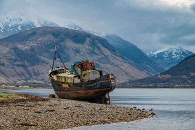 Abandoned boat on shore