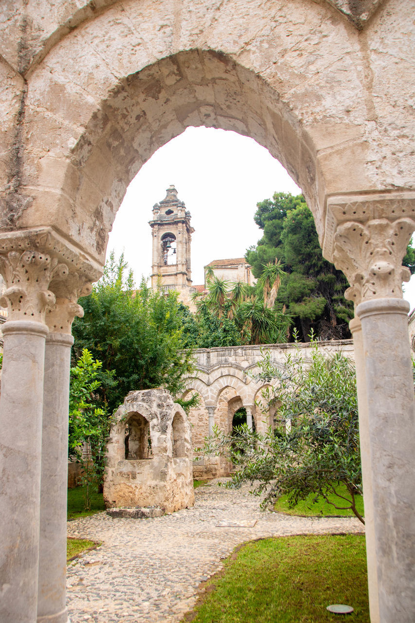 architecture, arch, built structure, history, the past, ruins, ancient history, building exterior, abbey, building, travel destinations, ancient, plant, old, no people, nature, travel, place of worship, day, religion, architectural column, old ruin, stone material, tourism, outdoors, tree, wall, medieval, belief