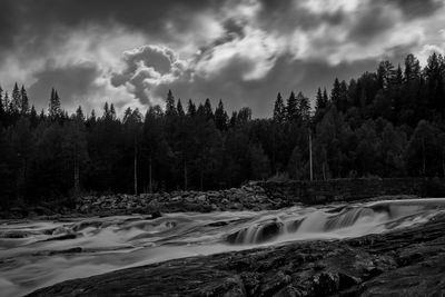 Scenic view of waterfall against sky