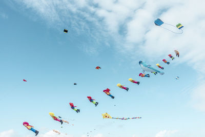 Low angle view of balloons flying against sky