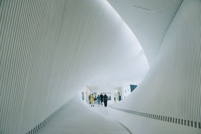 People walking in corridor of building