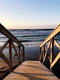 Pier over sea against clear sky