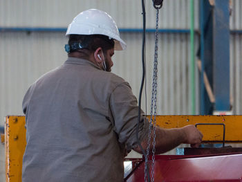 Rear view of man working at construction site