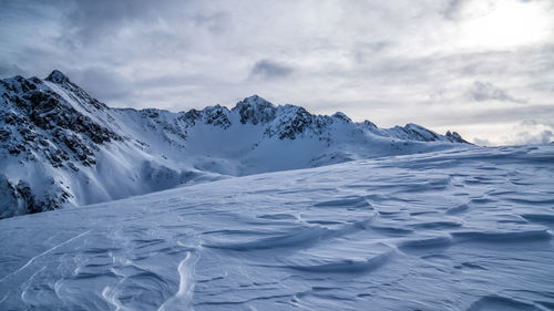 Scenic view of snowcapped mountains against sky