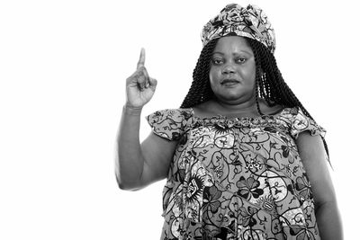 Portrait of woman standing against white background