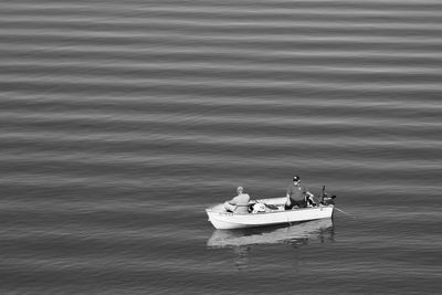 High angle view of people sailing boat in lake