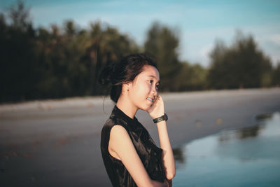 Portrait of smiling young woman looking away