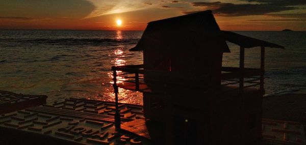 Scenic view of sea against orange sky