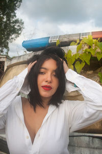 Portrait of beautiful young woman standing outdoors