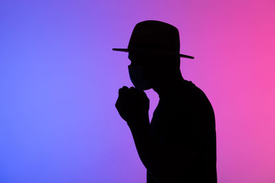 Silhouette man against blue background