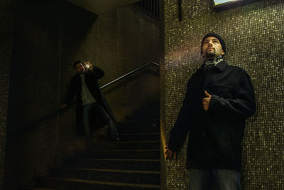 Low angle view of man standing on staircase