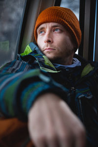 Handsome caucasian man with a beard looks thoughtfully to the side. beautiful winter portrait of a