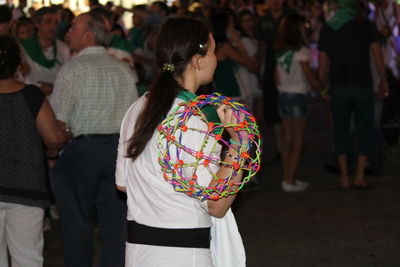 Rear view of woman carrying colorful toy