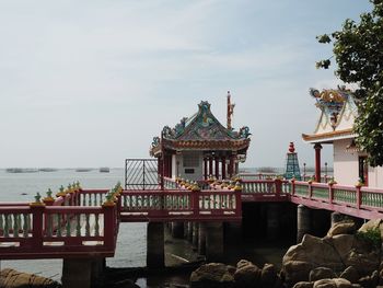 View of building by sea against sky