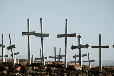 Cross on field against clear sky