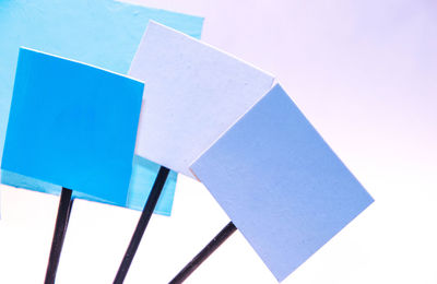 High angle view of multi colored paper against white background