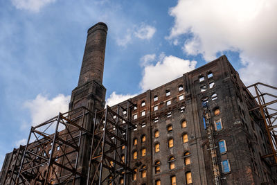 Low angle view of smoke stack against sky