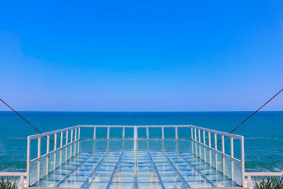 View of sea against clear blue sky