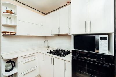 Modern white kitchen with gas stove