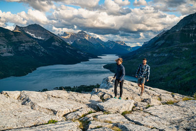 Full length of men on rocks against mountains