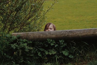 Portrait of woman sitting on tree