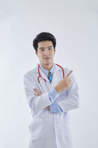 Young man standing against white background
