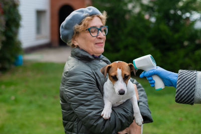 Full length of woman holding dog