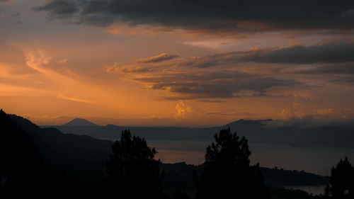 Scenic view of silhouette mountains against sky at sunset