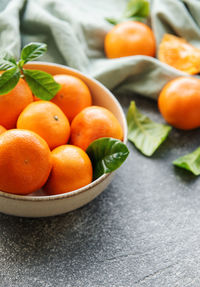 Fresh citrus fruits tangerines, oranges on a concrete background