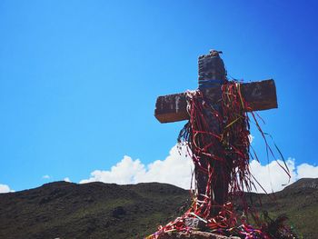 Low angle view of cross against clear sky