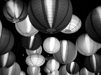 Low angle view of illuminated lanterns hanging from ceiling