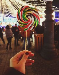 Midsection of woman holding multi colored candies