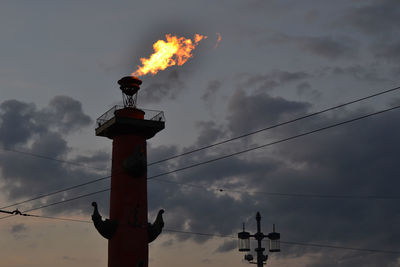 Fire torch on rostral column against sky